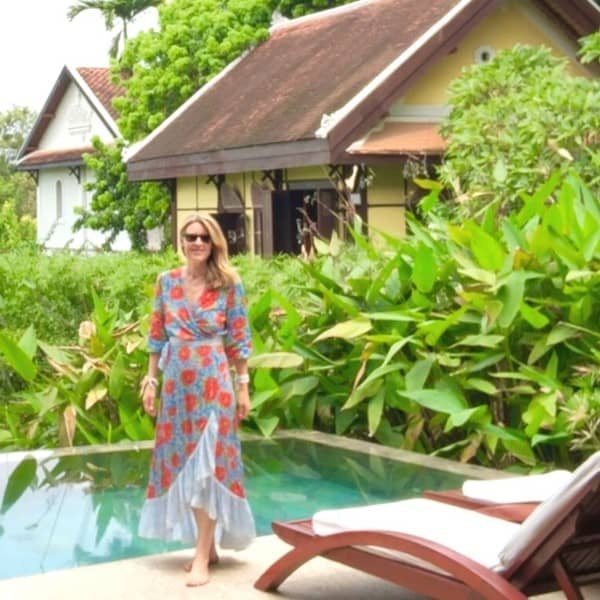 Midlife Globetrotter in Laos, wearing a flowered dress from her capsule wardrobe