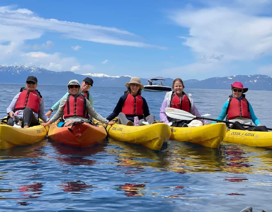 Five midlife women are pictured in kayaks on Lake Tahoe.