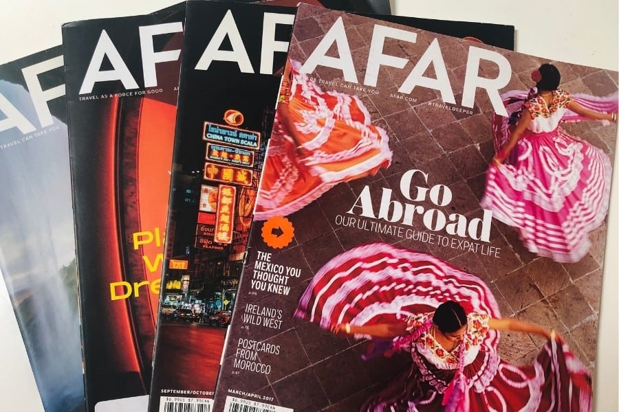A selection of AFAR travel magazines are fanned out on a table