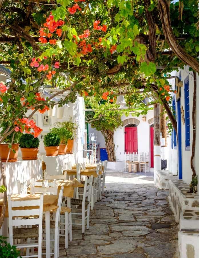 A whitewashed laneway with orange bougainvillea on the island of Amorgos, in the Cyclades Islands of Greece. Amorgos is a favorite of Athens tour guide Penelope Triantafyllidou.
