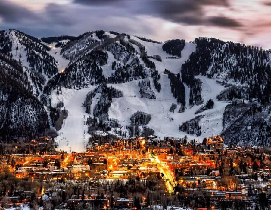 The town of Aspen Colorado at night with Aspen ski hill beyond, a dream girls trip destination
