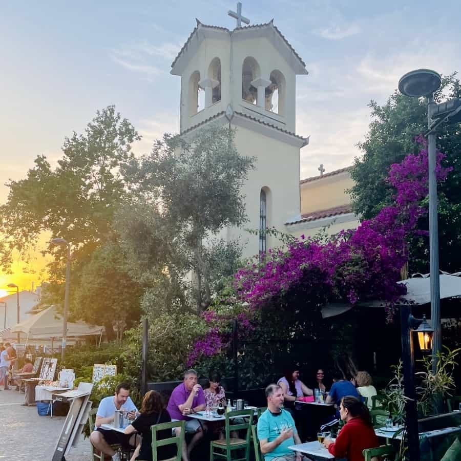 Athens Plaka neighborhood with people sitting in outdoor cafes