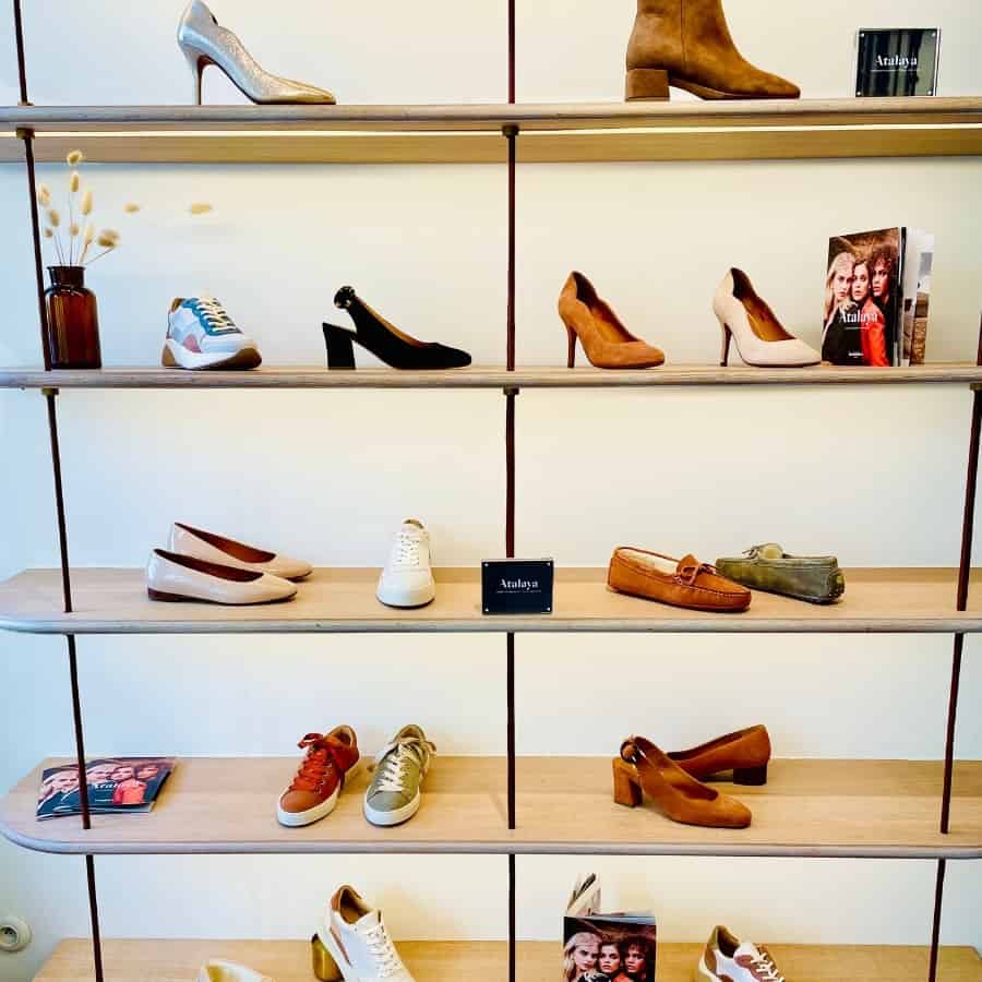 A shelving display filled with a variety of shoes at Bobbies in Paris