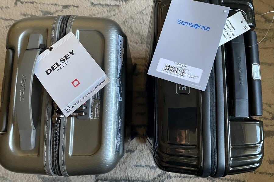 Delsey and Samsonite carry-on bags stand side by side
