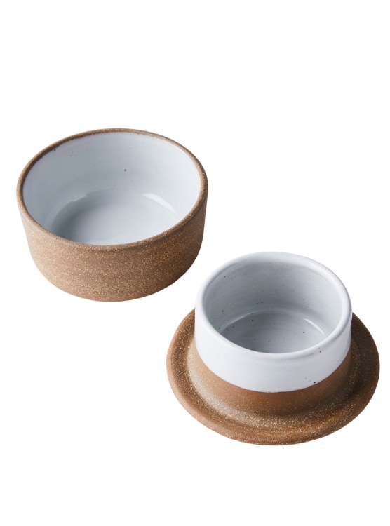 French butter keeper pictured open with a separate top and bottom. It is a natural clay color and white.