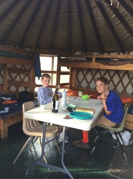 Two boys play a card game inside a Yurt in State Forest State Park