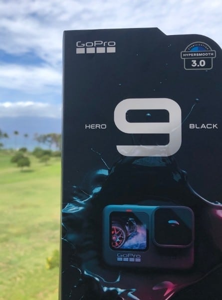 The GoPro Hero9 Black with the ocean and palm trees beyond it