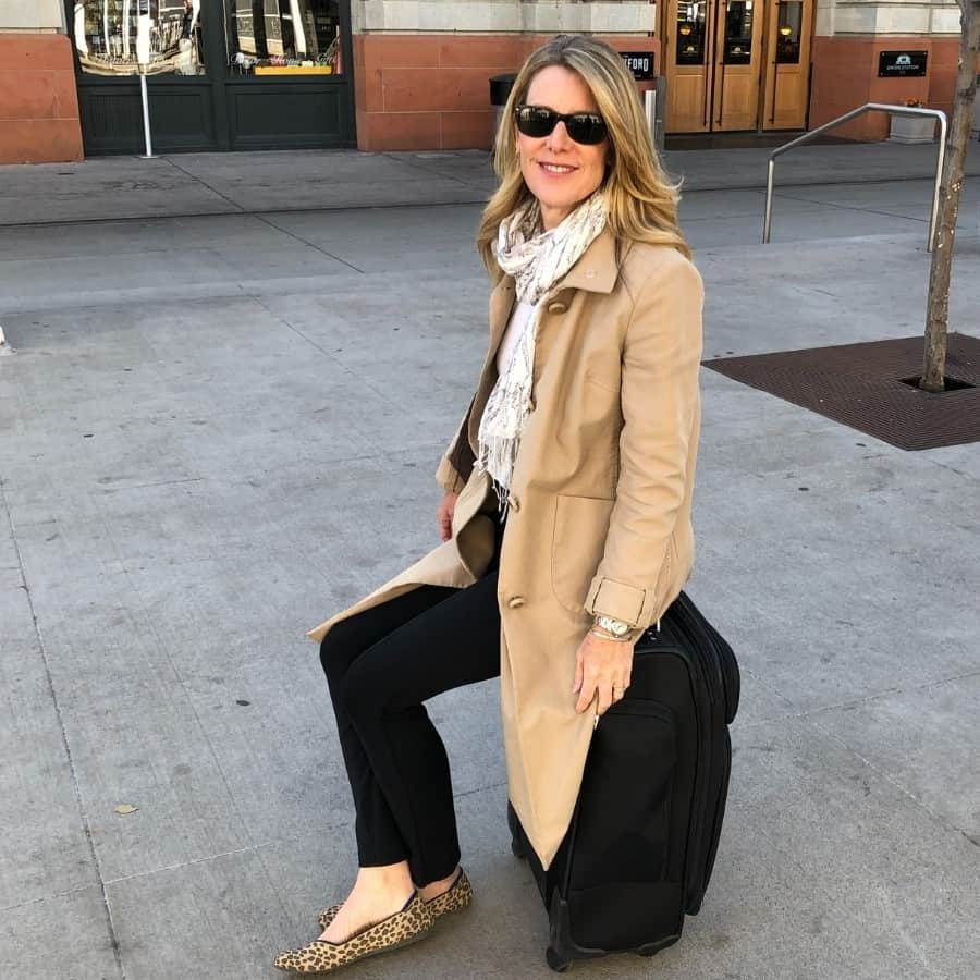 Susan sits on her Samsonite carry on which weighs 10 pounds