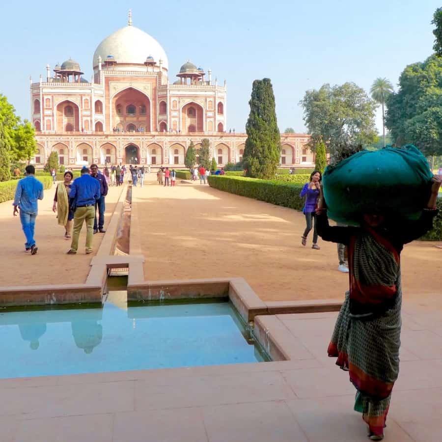 Indians walk in front of Humayun Tomb, one of the most famous historical places in Delhi