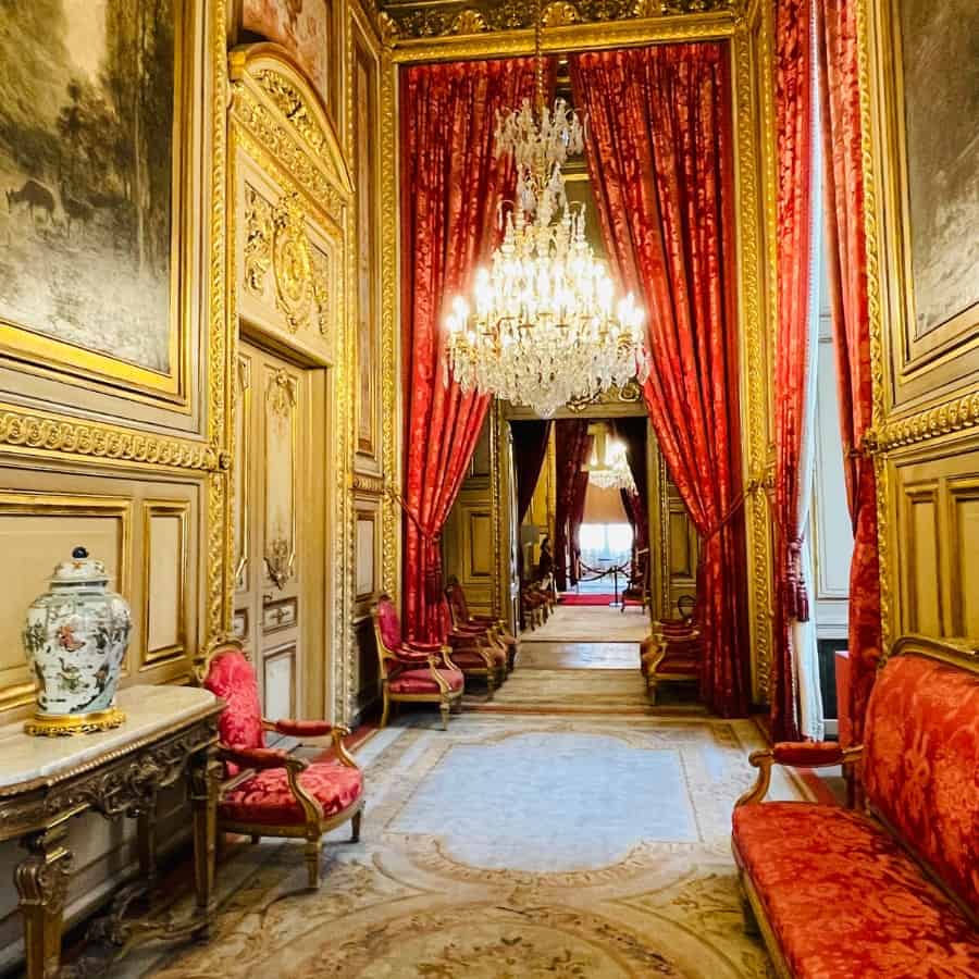 The Napoleon III Apartments at the Louvre in Paris, decorated in opulent red and gold as it was in 1865 when the Louvre was a palace.