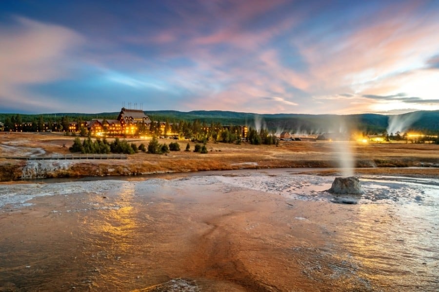 Old Faithful geyser with the Old Faithful hotel beyond