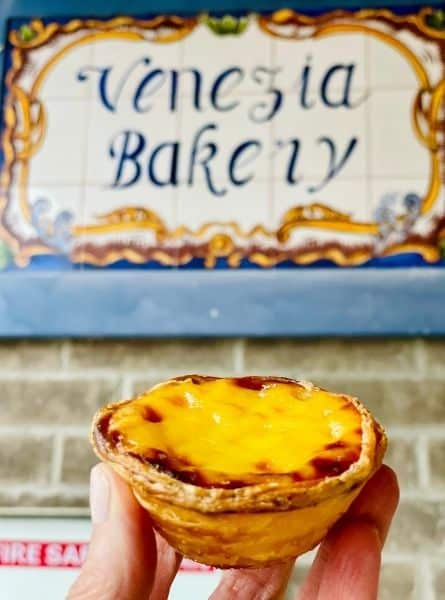Susan holds a portuguese tart from Venezia bakery in Toronto