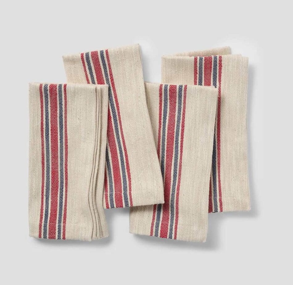 Four french striped cotton napkins. A cream background with red and blue stripes.