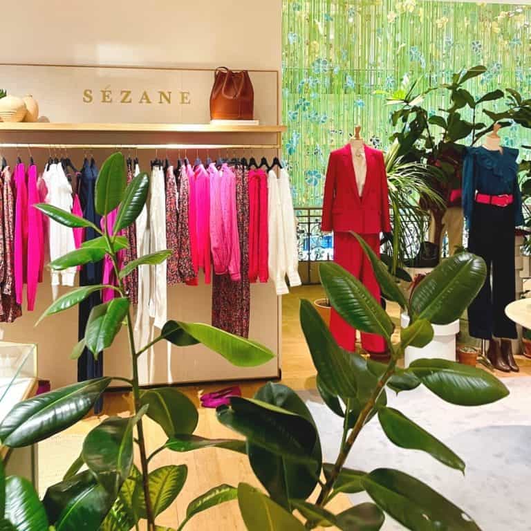 A colourful rack of clothing by Sezane Paris, an affordable French clothing brand