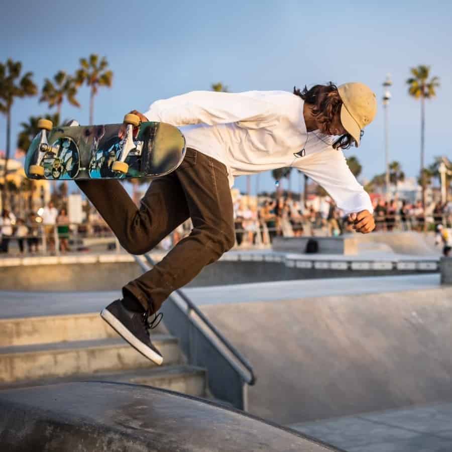 A skateboarder does a trick at the skate park Venice Beach California