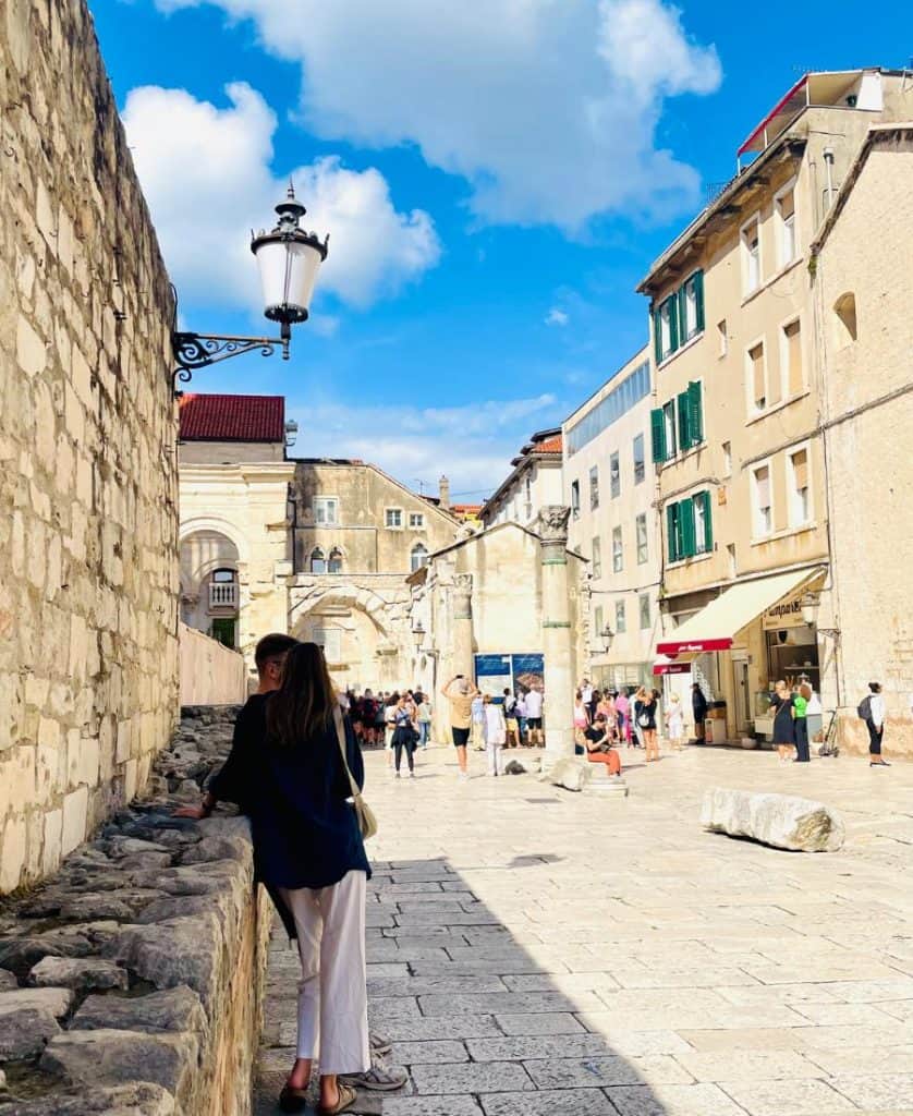 Two people are in the foreground at the Palace of Diocletian in Split, Croatia.