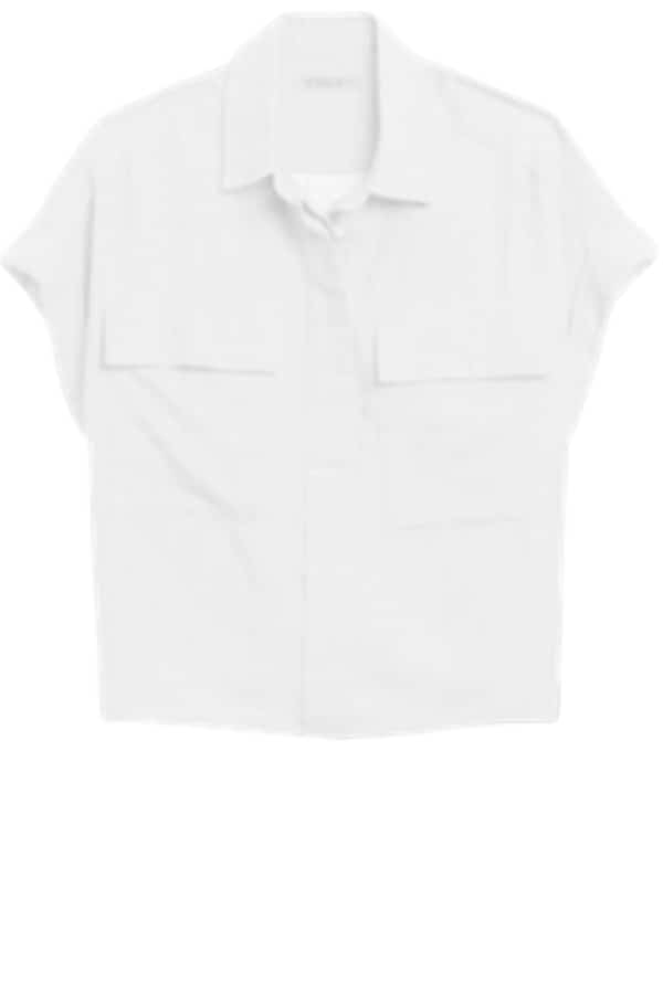 A white short-sleeved roll cuff shirt is a staple in a spring capsule wardrobe for vacation