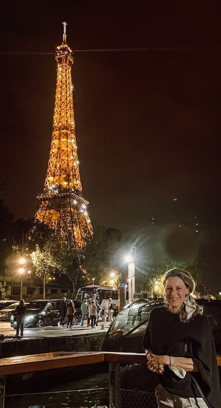 Susan Heinrich on a Bateaux Parisiens Cruise in Paris with a view of the Eiffel Tower just behind her