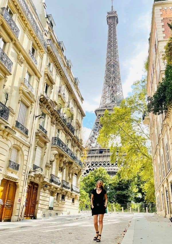 Susan Heinrich stands in front of the Eiffel Tower on the rue de l'universite Paris