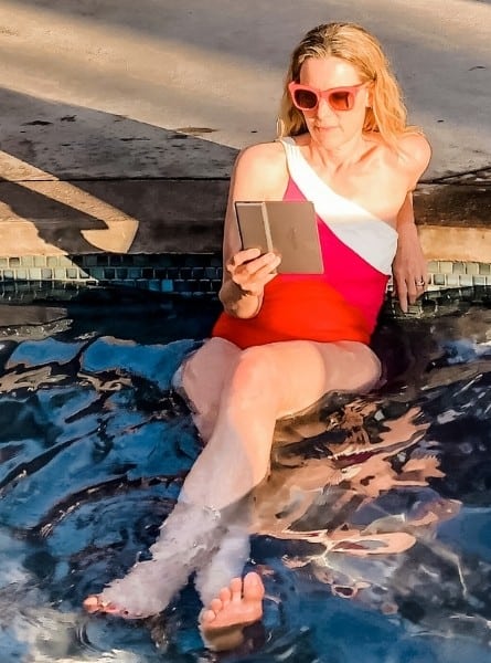 Susan Heinrich reads her Kindle E-reader in a pool in Maui