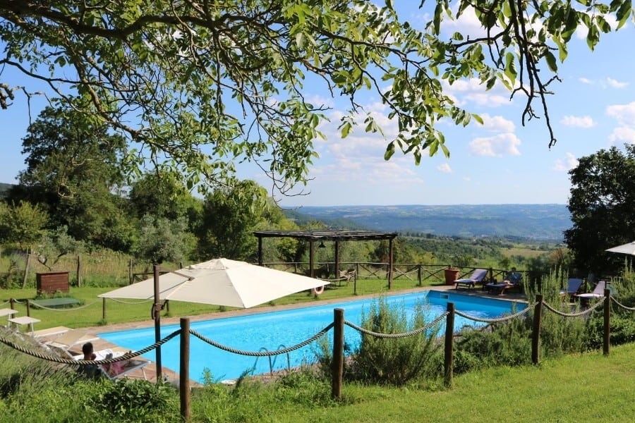 The swimming pool at Antica Olivaia with views of the Umbrian hills and the town of Orvieto