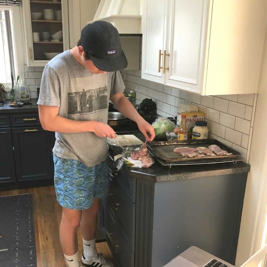 A 20-year-old man prepares dinner at home