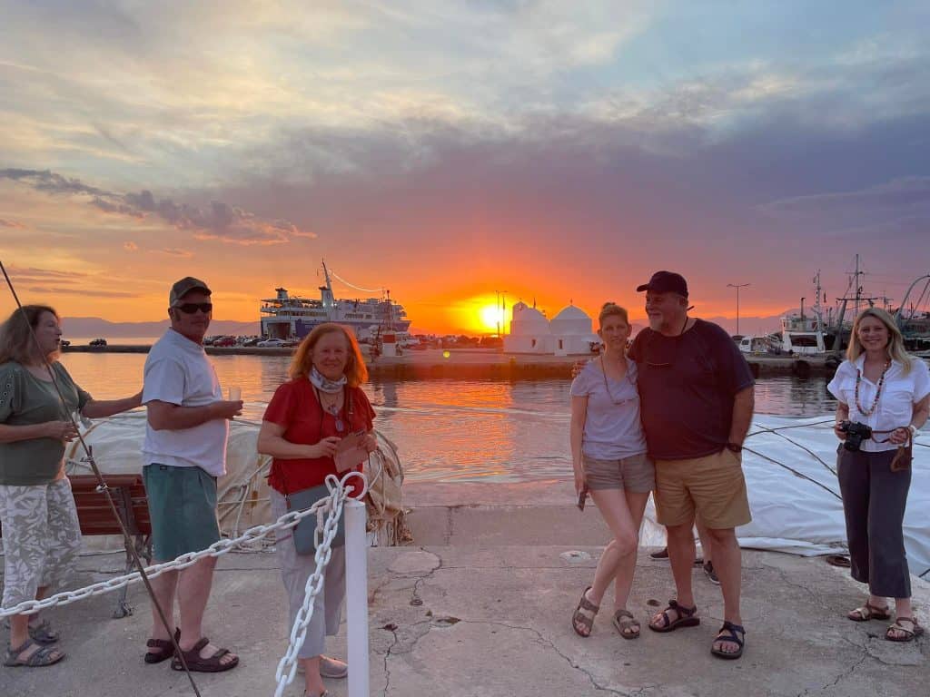 A small group of travelers at sunset in Greece, during a sailing excursion with Traverse Journeys.