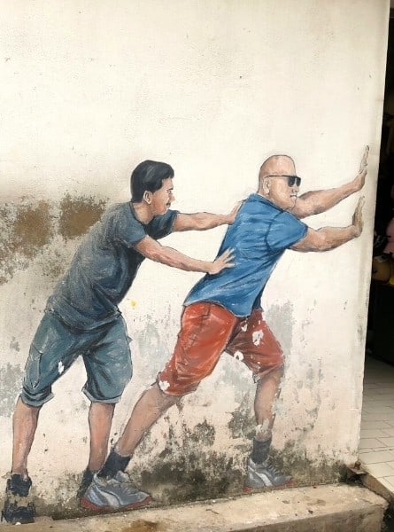 Two Men Pushing Door Mural in george Town Malaysia