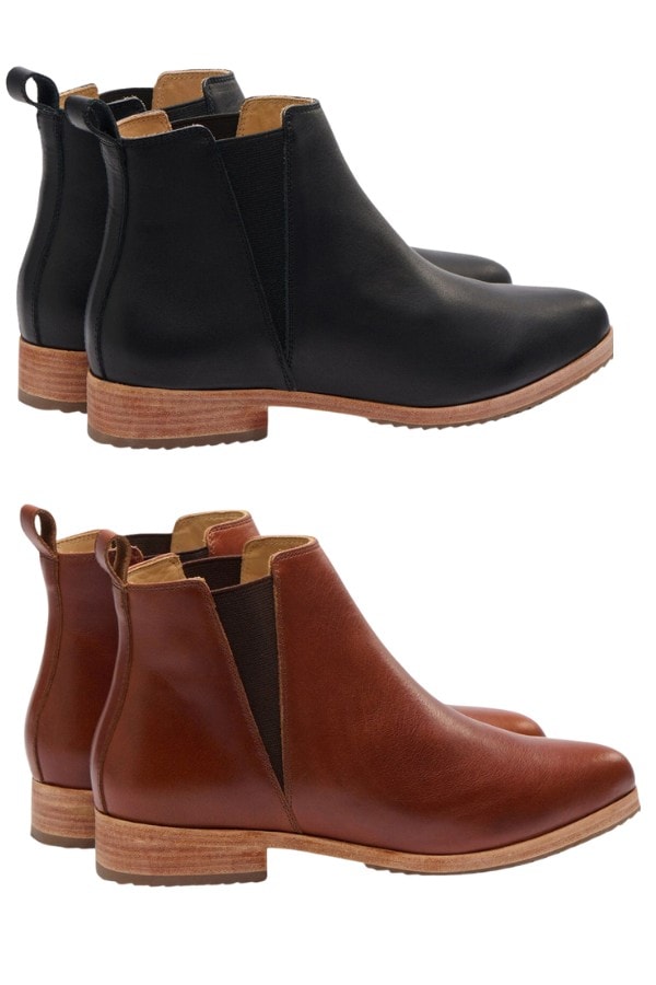 Two pairs of chelsea-style women's ankle boots are pictured. One in brown and one in black, They both have tan soles.