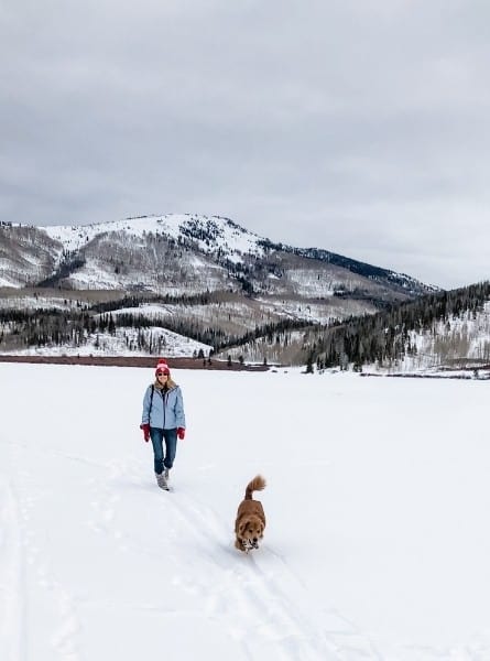 A woman hiking with her dog at Pearl Lake State Park in winter