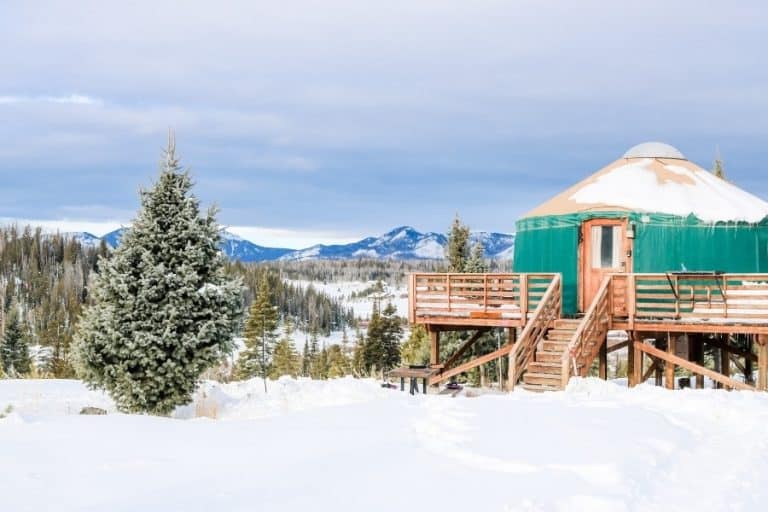 A yurt with mountains beyond at Pearl Lake Colorado in winter